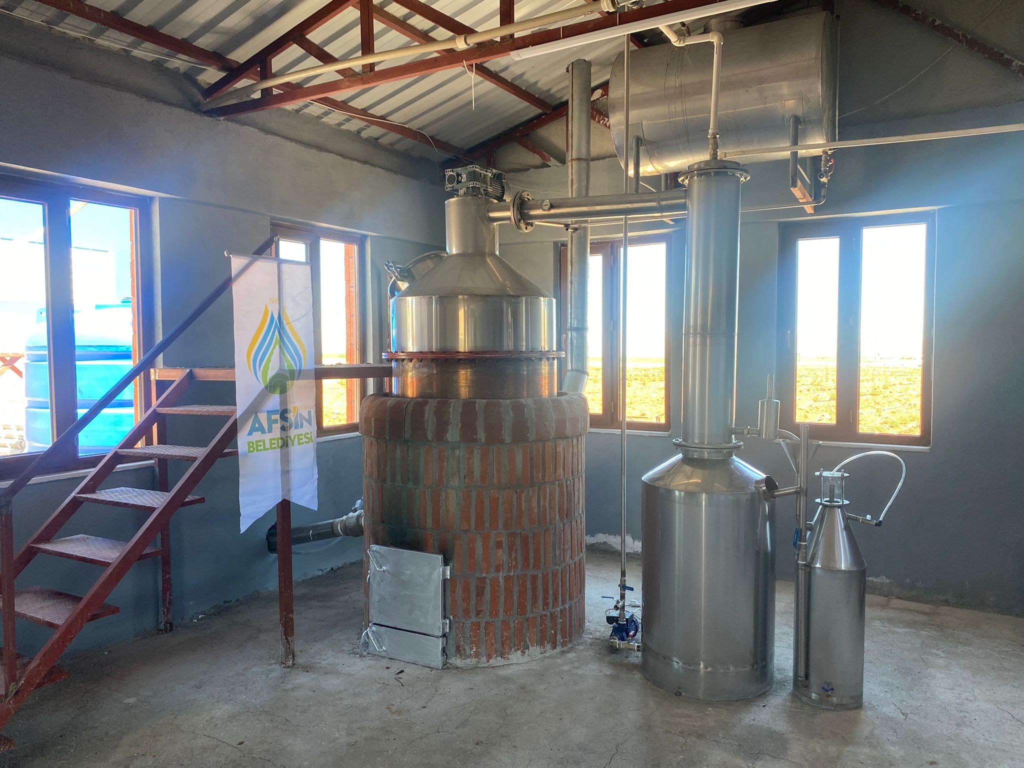 Copper essential oil distillation unit with platform and access stairs