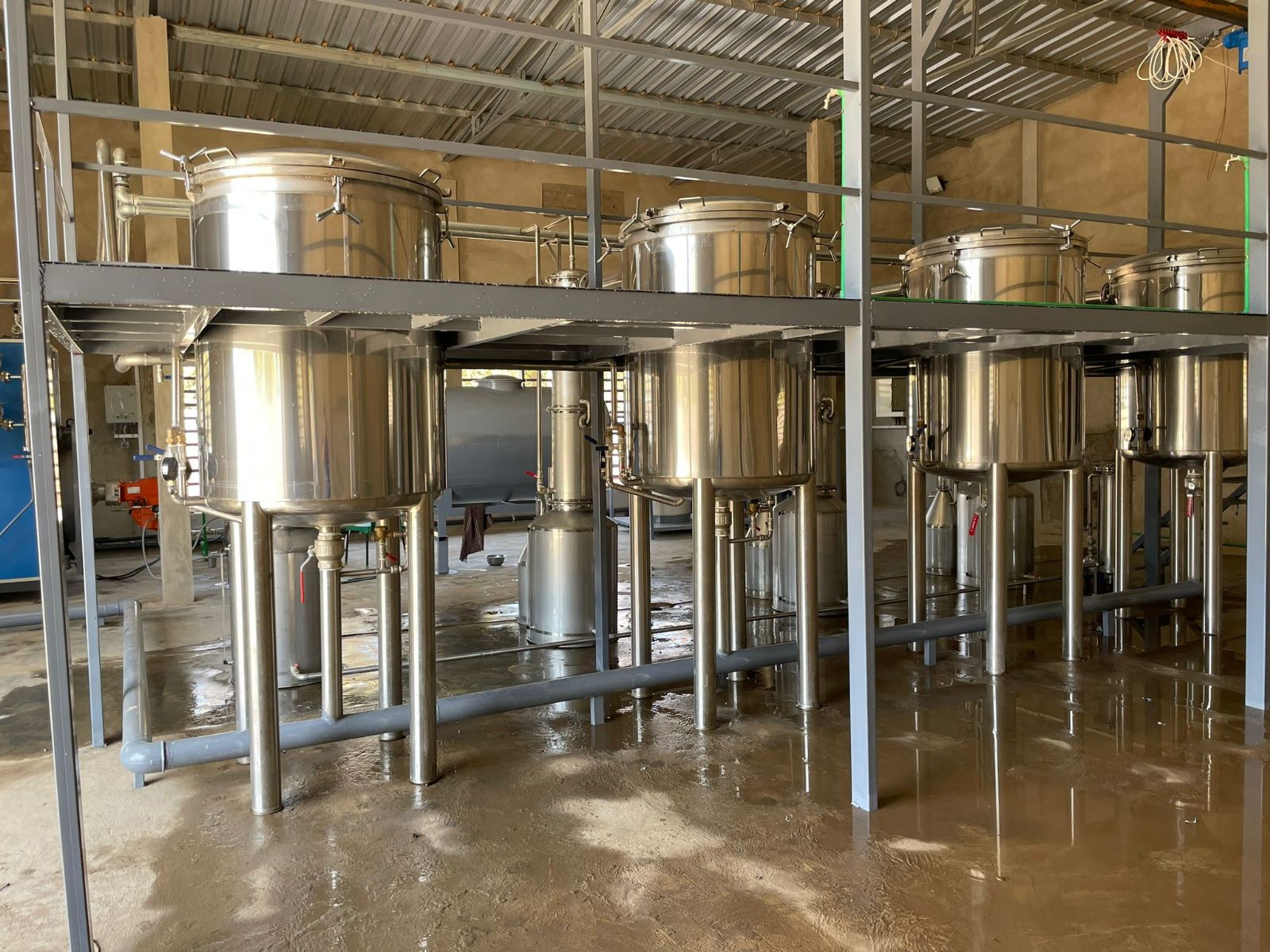 Stainless steel essential oil distillation units installed on a steel service platform, Dünder Makine