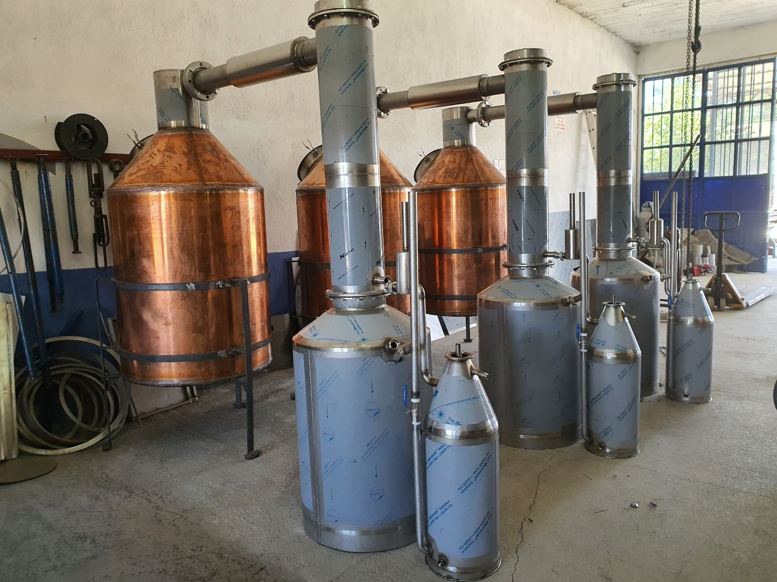 Copper stills with stainless steel condenser columns in a rose distillery