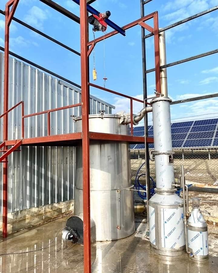 Steam distillation unit with condenser on a steel frame for herb oils