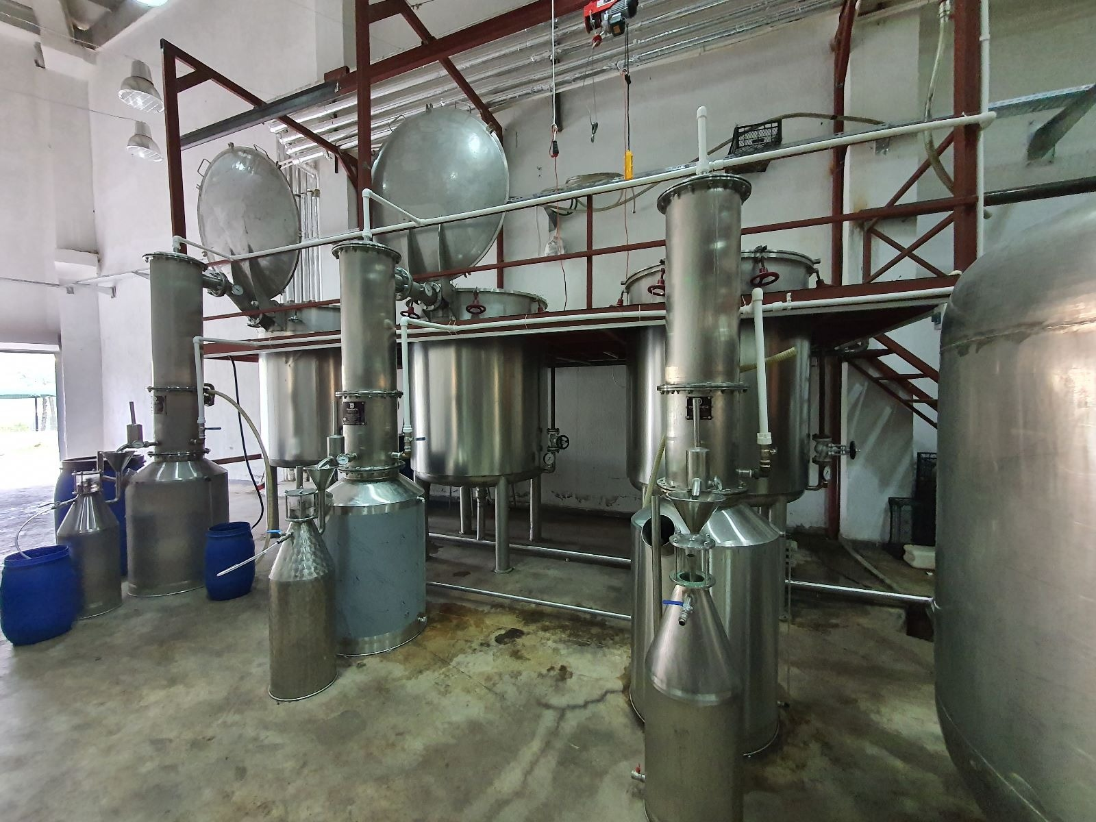 Indoor essential oil distillation plant with stainless steel stills and tanks