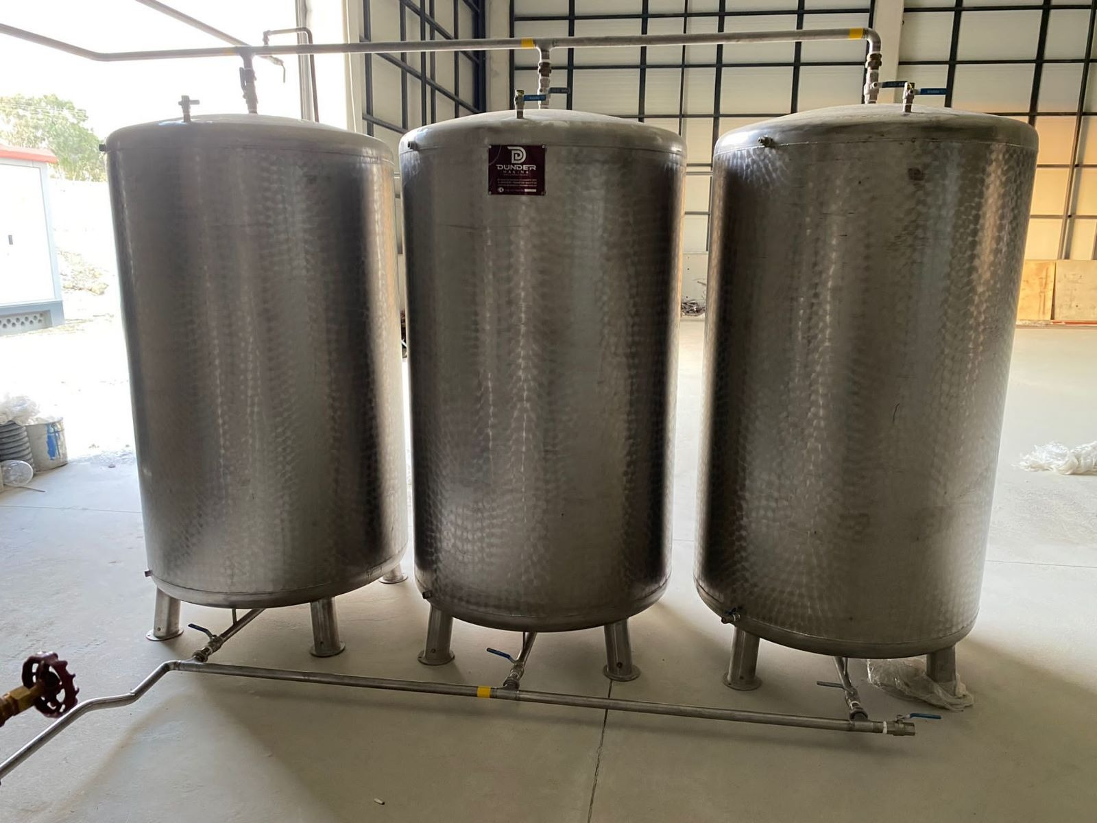 Three stainless steel product tanks in an extraction plant