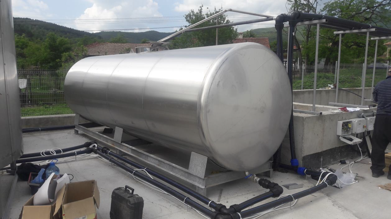 Large horizontal stainless steel tank installed outdoors at a plant