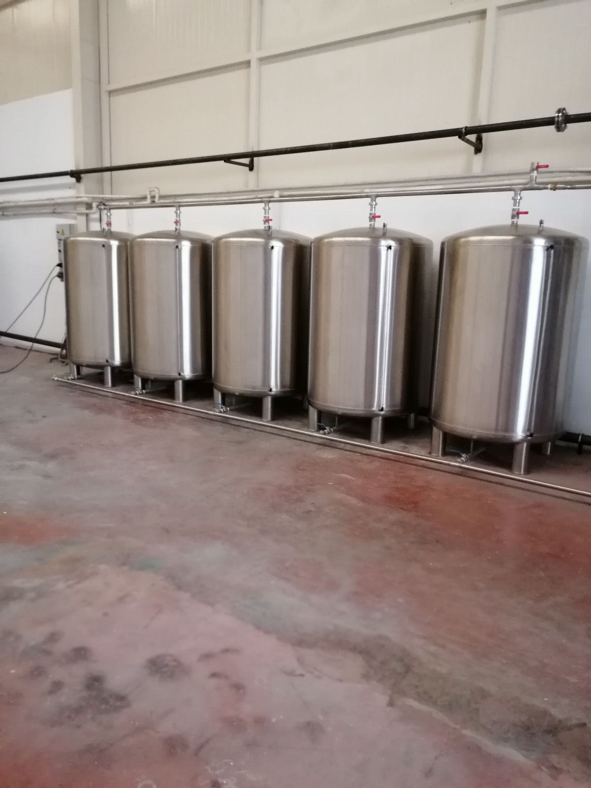 Fila de tanques de acero inoxidable listos para su envío en la fábrica de Dünder Makine.