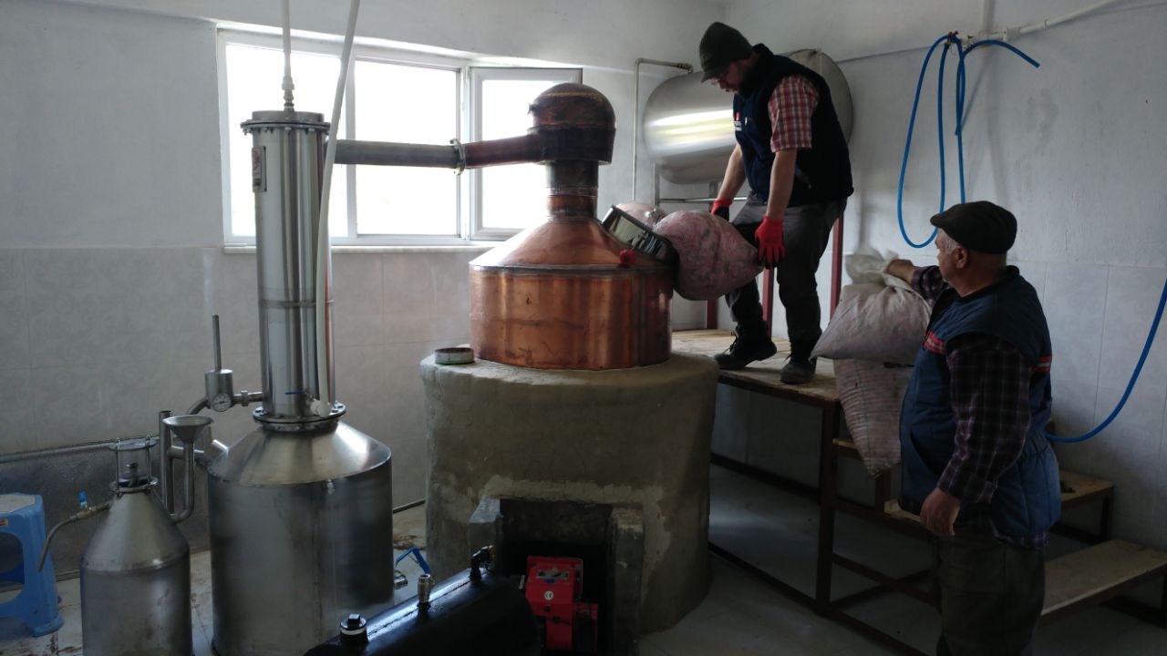 Workshop team assembling and checking a copper rose still before shipping