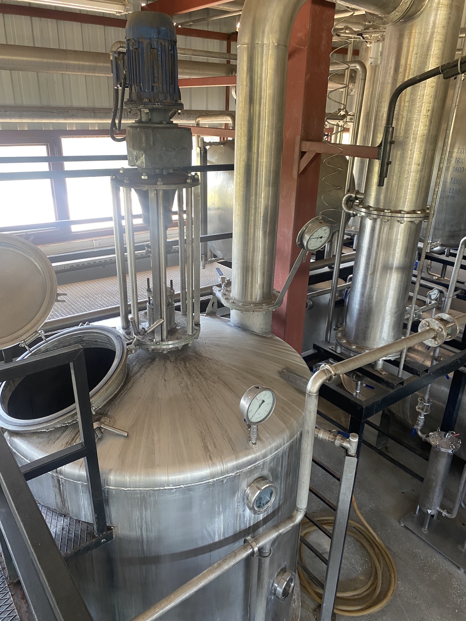 Stainless steel distillation still and pipework inside an essential oil plant