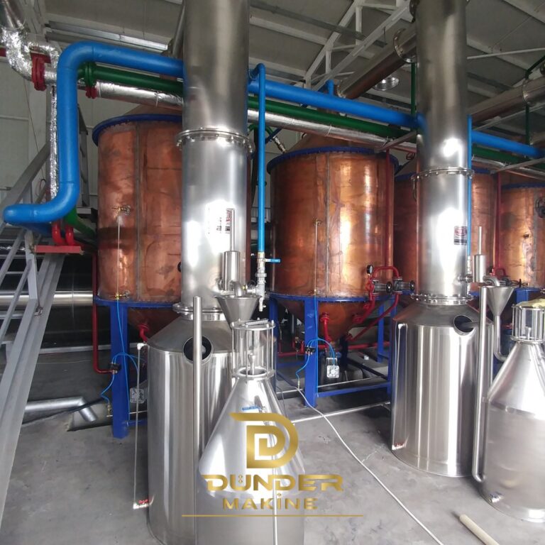 Copper still for rose oil with stainless steel condenser columns and Florentine separators by Dünder Makine