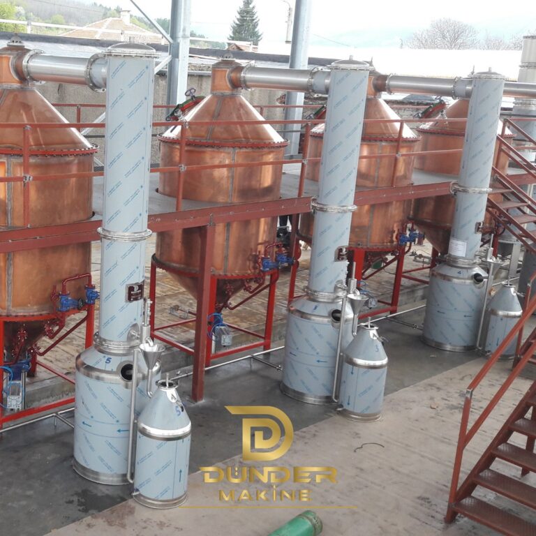 Condenser column beside copper rose stills with Florentine separators on a red steel platform