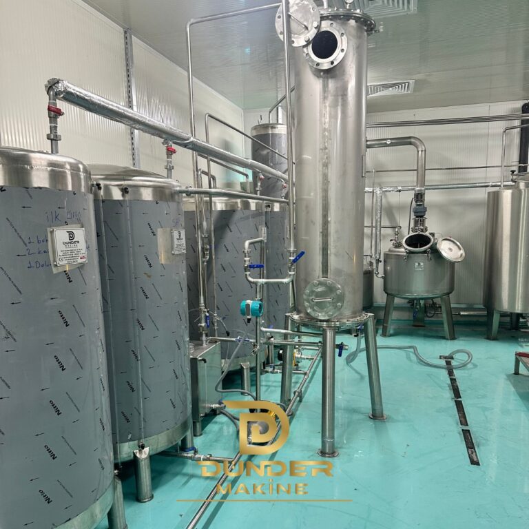 Stainless steel distillation column with product tanks and jacketed reactor in a clean production room