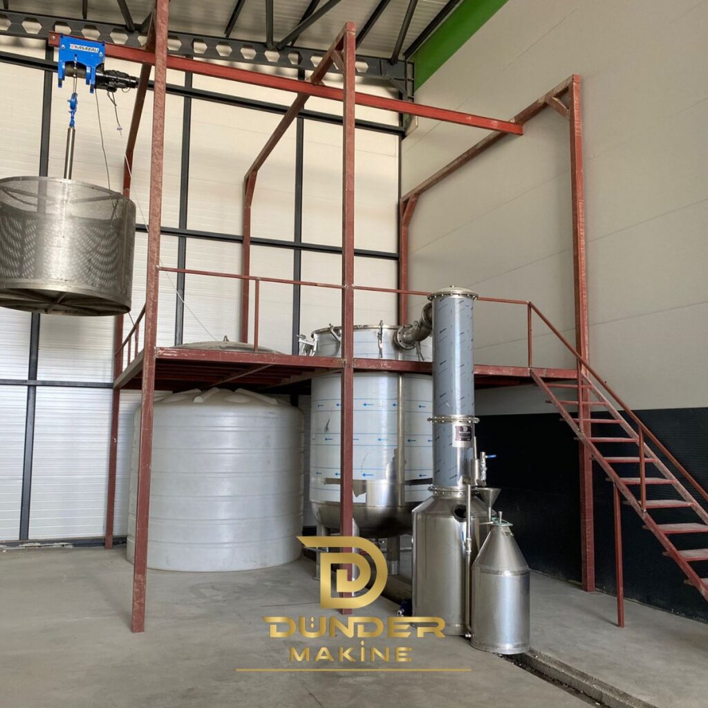 Basket loading system with electric hoist, steel platform and distillation still by Dünder Makine