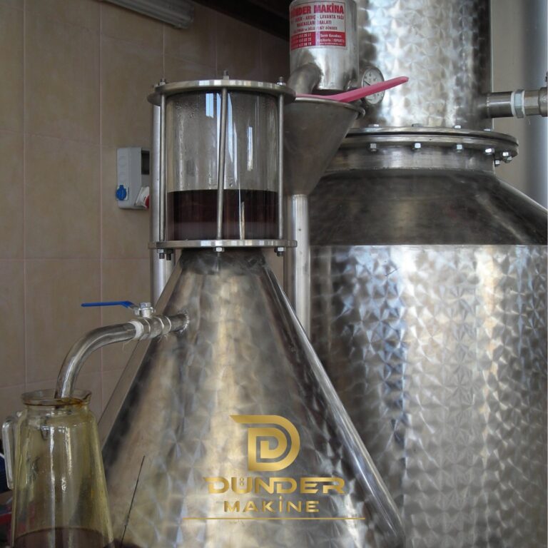 Florentine separator with sight glass showing essential oil layer and collection jug by Dünder Makine