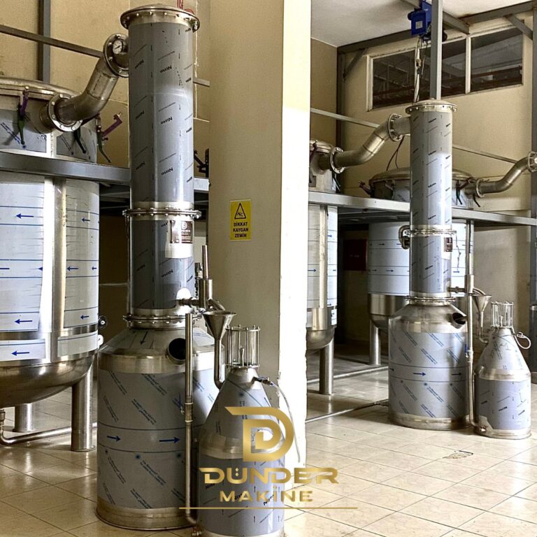 Two steam distillation unit lines with condenser columns and Florentine separators on a steel platform